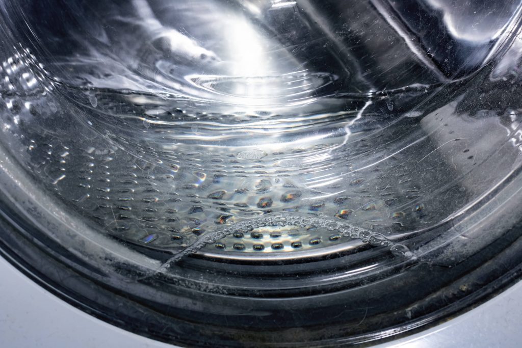 View of a washing machine that needs a vent of its drain pipe