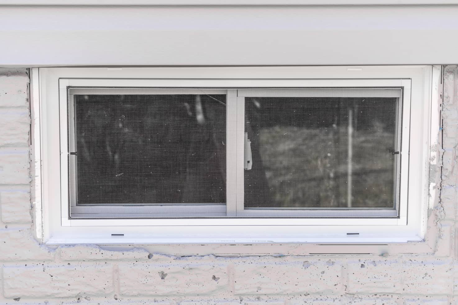 This basement window needs some serious re-caulking and sealer.