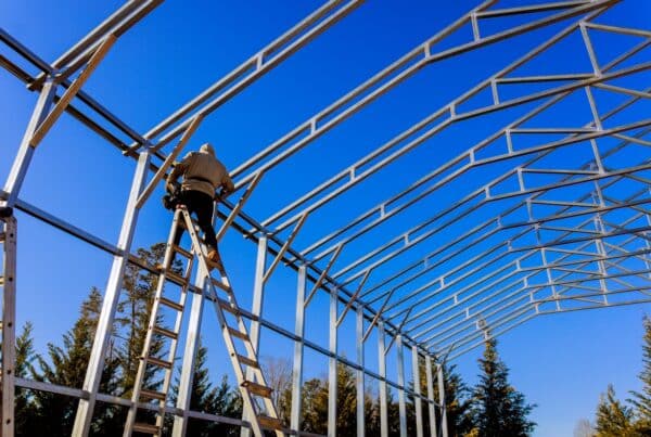 Stainless steel roof structure for future roof under construction. Development of metal roofing frame on homes.